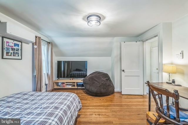 1381 Burmont Rd, Drexel Hill, PA 19026 - bedroom featuring light wood-type flooring, a wall mounted AC, and vaulted ceiling