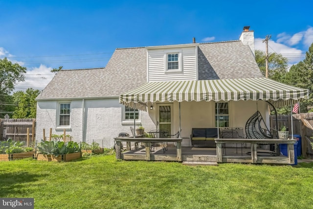 1381 Burmont Rd, Drexel Hill, PA 19026 - back of property with stucco siding, a garden, roof with shingles, and outdoor lounge area
