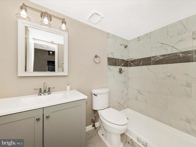 6994 Hanover Pkwy Unit 101, Greenbelt, MD 20770 - bathroom with marble finish floors, toilet, a tile shower, vanity, and baseboards