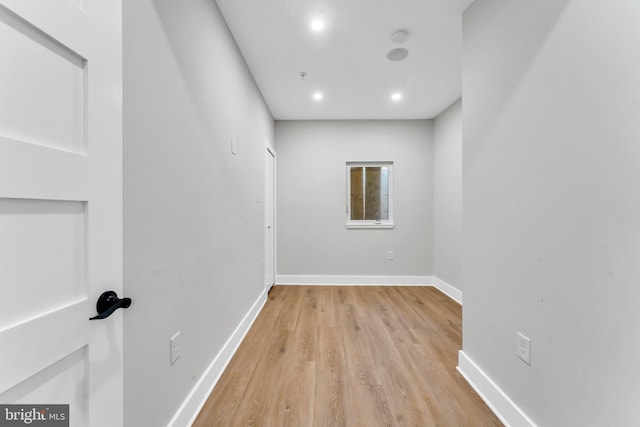 spare room with light wood-type flooring, baseboards, recessed lighting, and a smoke detector
