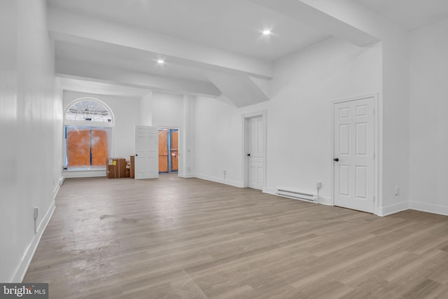 19 Valley St, Lewistown, PA 17044 - unfurnished living room with wood finished floors, a baseboard heating unit, baseboards, recessed lighting, and a high ceiling