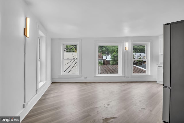 19 Valley St, Lewistown, PA 17044 - unfurnished living room featuring plenty of natural light, wood finished floors, and baseboards
