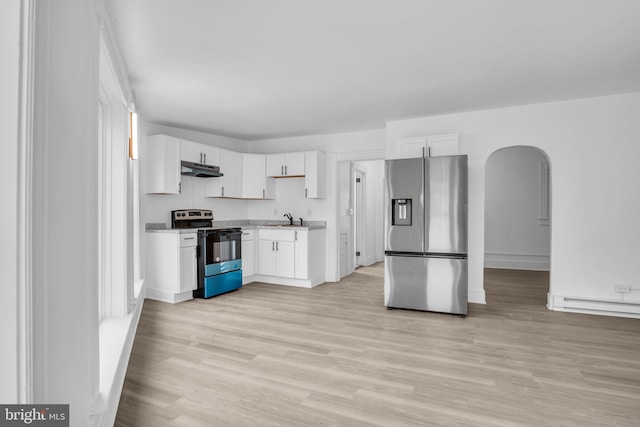 19 Valley St, Lewistown, PA 17044 - kitchen featuring electric range oven, stainless steel refrigerator with ice dispenser, arched walkways, light wood-style floors, and light countertops