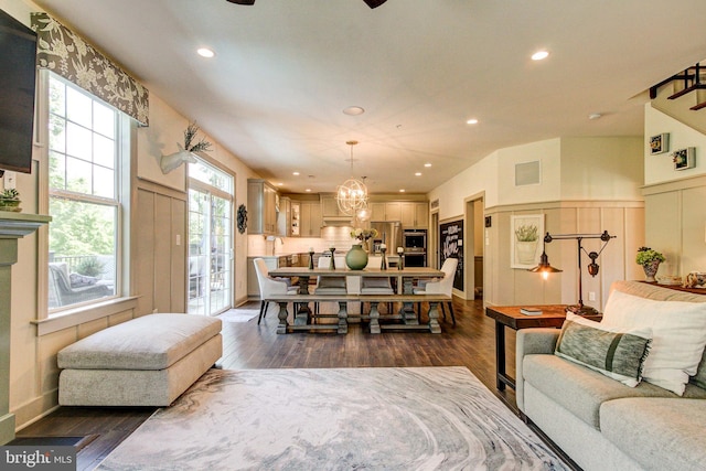 living area with dark wood-style floors, recessed lighting, a chandelier, and ceiling fan