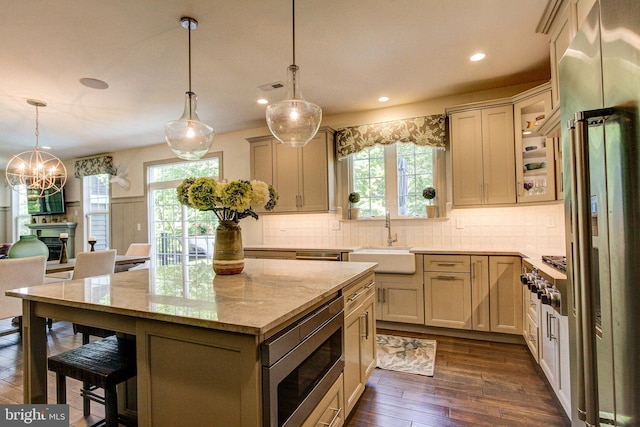 kitchen featuring a sink, dark wood finished floors, appliances with stainless steel finishes, plenty of natural light, and recessed lighting