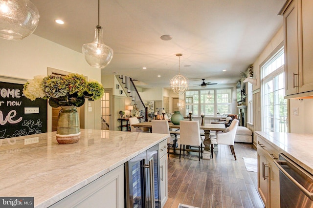 kitchen featuring beverage cooler, stainless steel dishwasher, dark wood-style floors, recessed lighting, and decorative light fixtures