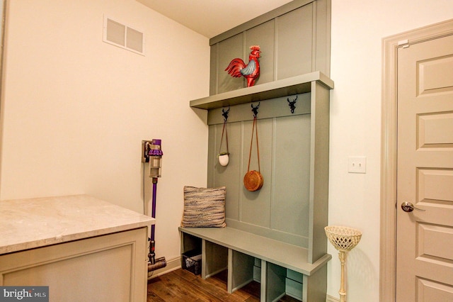 mudroom with dark wood-style floors and baseboards