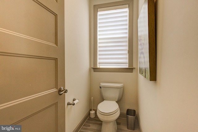 bathroom featuring toilet, baseboards, and wood finished floors