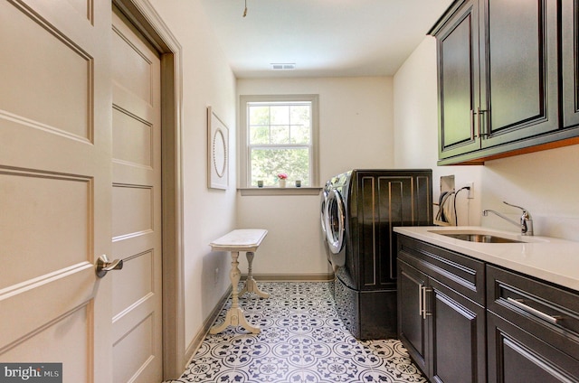 laundry room with cabinet space, baseboards, washer hookup, and light floors
