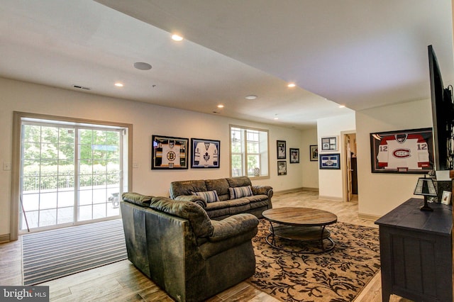 living room featuring recessed lighting and baseboards
