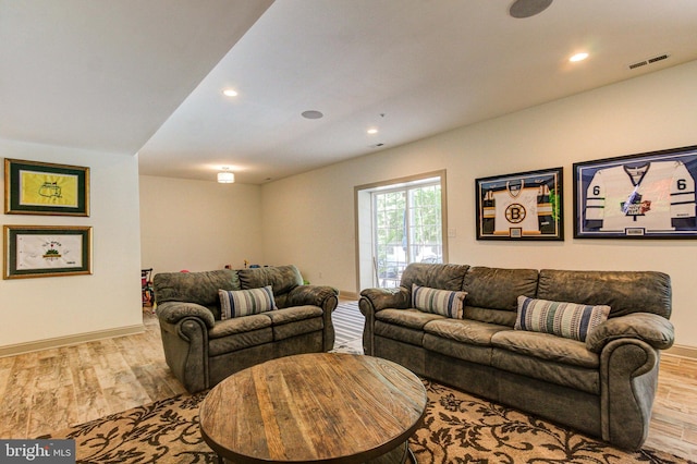 living area with wood finished floors, baseboards, and recessed lighting