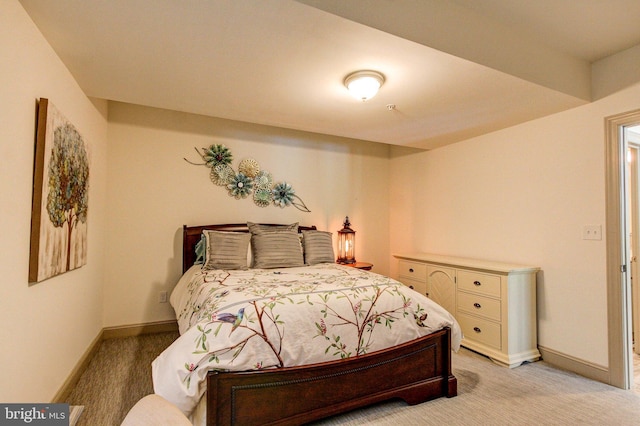 bedroom with light carpet and baseboards