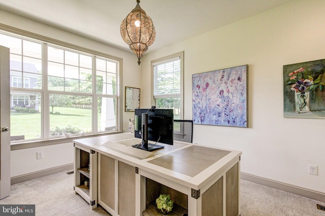 office space with baseboards and light carpet