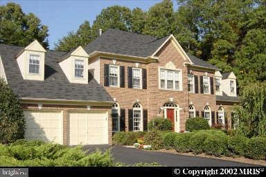 8622 Cross Chase Ct, Fairfax Station, VA 22039 - colonial-style house featuring asphalt driveway and a garage