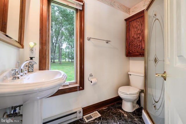 8320 Ingleton Cir W, Easton, MD 21601 - bathroom with toilet, a baseboard heating unit, marble finish floors, baseboards, and a sink