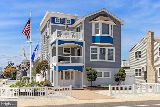 127 E 13th St, Long Beach Township, NJ 08008 - view of front of property featuring a balcony and a fenced front yard