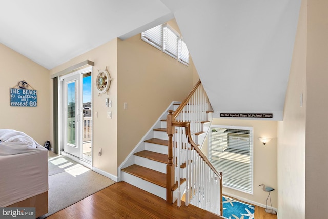 127 E 13th St, Long Beach Township, NJ 08008 - stairs with plenty of natural light, wood finished floors, lofted ceiling, and baseboards