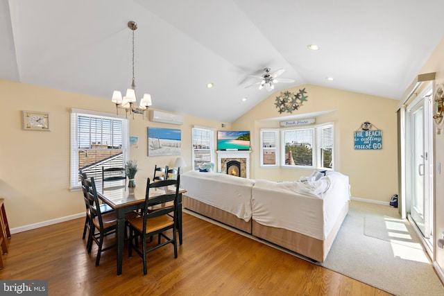 127 E 13th St, Long Beach Township, NJ 08008 - dining room featuring lofted ceiling, a chandelier, a wall mounted air conditioner, plenty of natural light, and wood finished floors