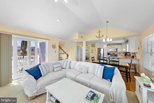 127 E 13th St, Long Beach Township, NJ 08008 - living room with lofted ceiling, healthy amount of natural light, a ceiling fan, stairs, and a chandelier