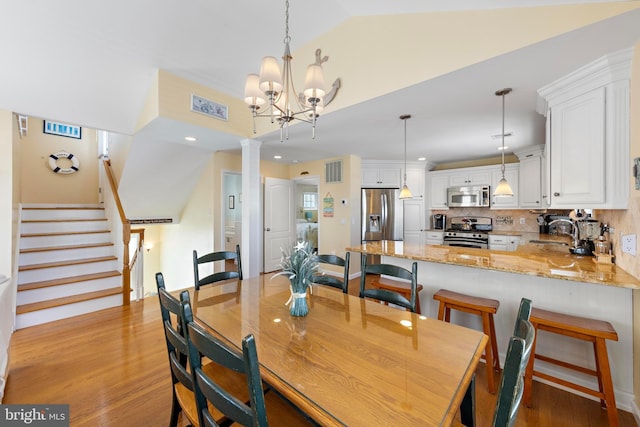 127 E 13th St, Long Beach Township, NJ 08008 - dining space with ornate columns, light wood-type flooring, recessed lighting, vaulted ceiling, and stairway
