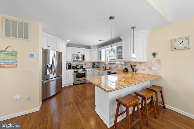 127 E 13th St, Long Beach Township, NJ 08008 - kitchen featuring appliances with stainless steel finishes, a peninsula, glass insert cabinets, baseboards, and light stone countertops