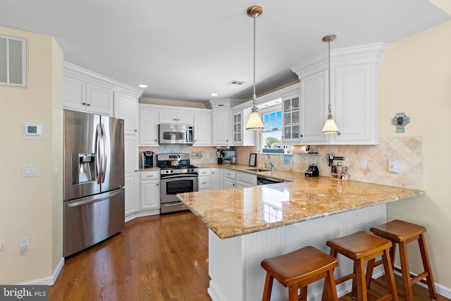 127 E 13th St, Long Beach Township, NJ 08008 - kitchen featuring appliances with stainless steel finishes, a peninsula, glass insert cabinets, white cabinetry, and a sink