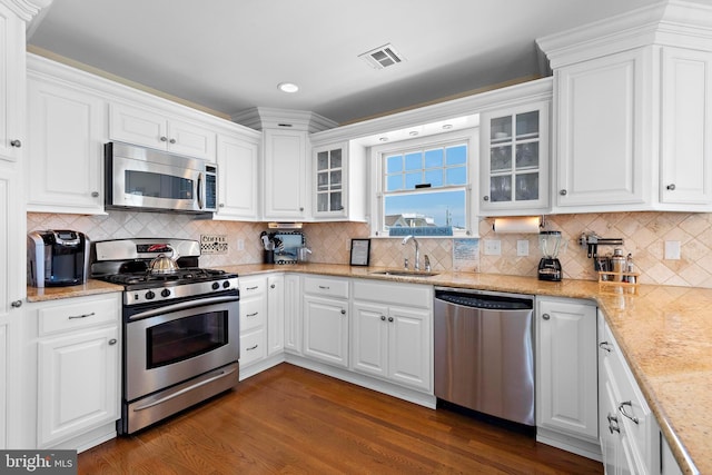 127 E 13th St, Long Beach Township, NJ 08008 - kitchen with stainless steel appliances, a sink, white cabinets, and recessed lighting