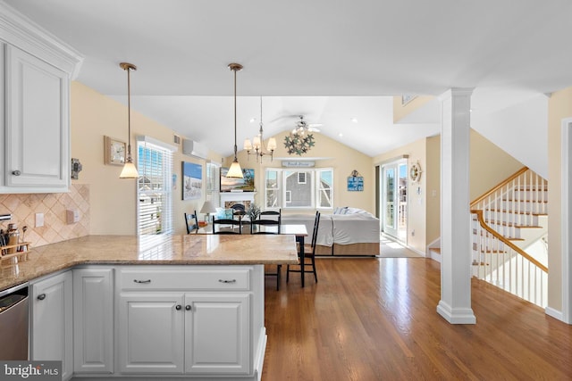 127 E 13th St, Long Beach Township, NJ 08008 - kitchen featuring wood finished floors, open floor plan, stainless steel dishwasher, tasteful backsplash, and white cabinetry