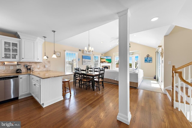 127 E 13th St, Long Beach Township, NJ 08008 - kitchen with dishwasher, dark wood finished floors, lofted ceiling, white cabinets, and a peninsula