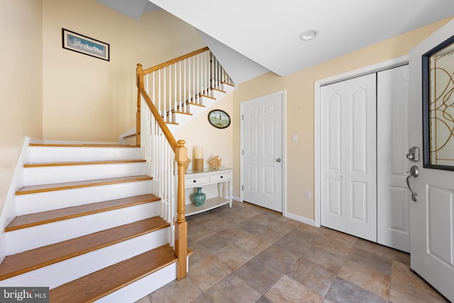 127 E 13th St, Long Beach Township, NJ 08008 - foyer entrance with stone finish floors, stairway, and baseboards