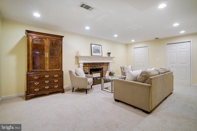 living room with light carpet, recessed lighting, ornamental molding, a brick fireplace, and baseboards