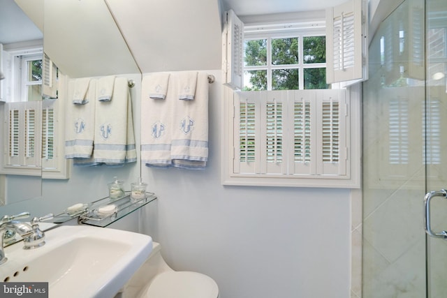 full bathroom with a sink, a stall shower, and toilet