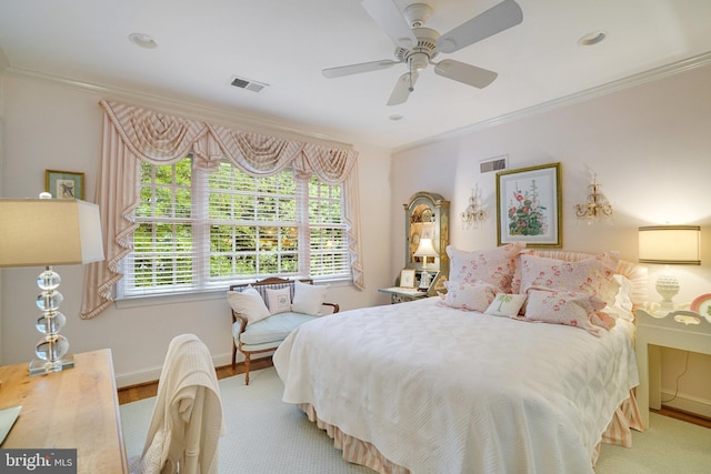 bedroom with multiple windows, crown molding, baseboards, a ceiling fan, and wood finished floors