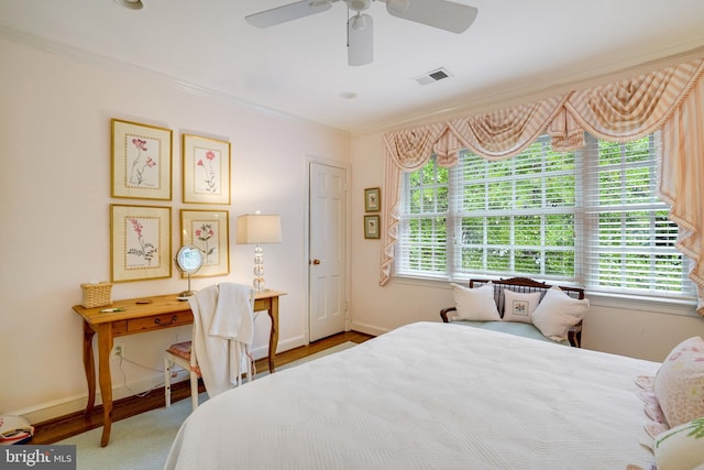 bedroom featuring multiple windows, baseboards, crown molding, and ceiling fan
