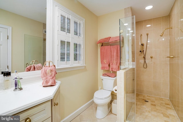 bathroom featuring vanity, toilet, a tile shower, tile patterned floors, and recessed lighting