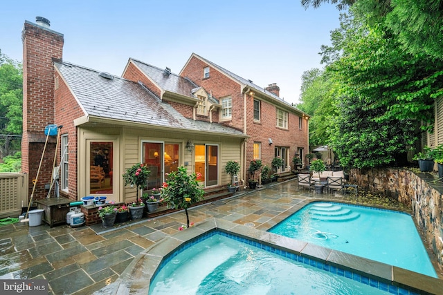 outdoor pool with a patio area and fence
