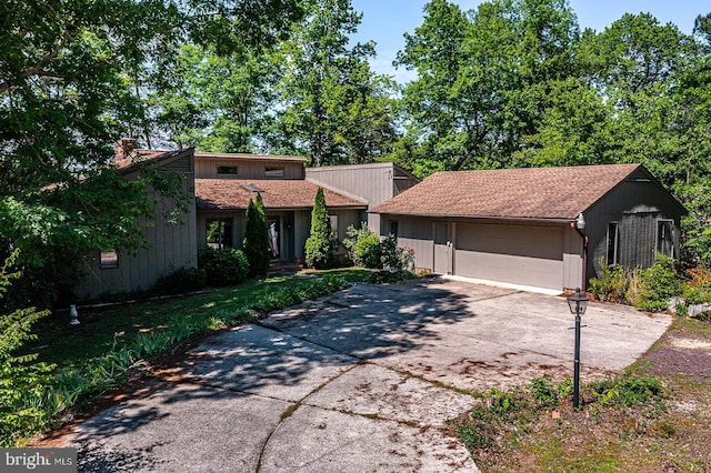 109 Kingfisher Cir, Weems, VA 22576 - mid-century home with concrete driveway and a garage