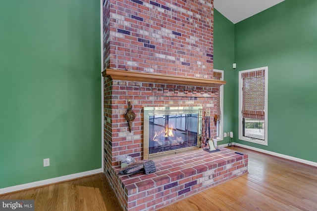 109 Kingfisher Cir, Weems, VA 22576 - detailed view of baseboards, a fireplace, and wood finished floors