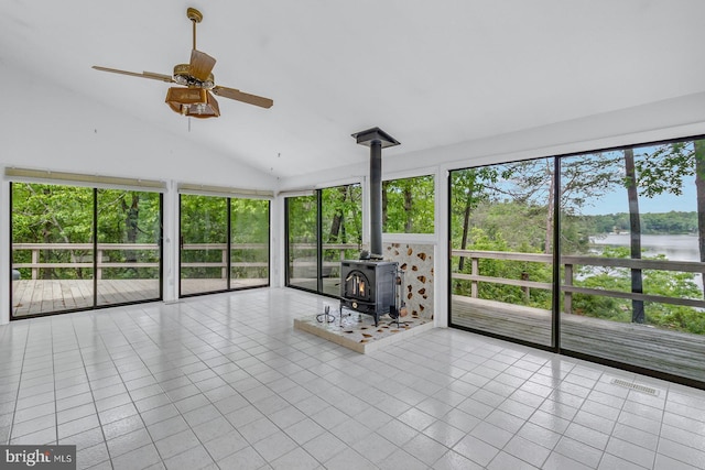 109 Kingfisher Cir, Weems, VA 22576 - unfurnished sunroom featuring a wood stove, a water view, and lofted ceiling
