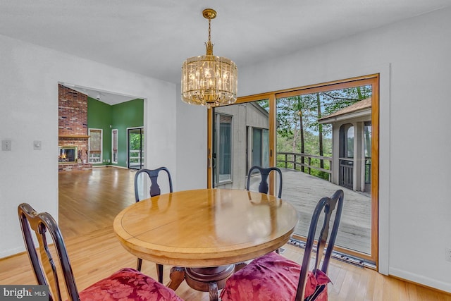 109 Kingfisher Cir, Weems, VA 22576 - dining area featuring light wood-style floors, a chandelier, and baseboards