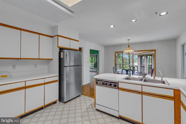 109 Kingfisher Cir, Weems, VA 22576 - kitchen featuring freestanding refrigerator, white dishwasher, light floors, a sink, and light countertops