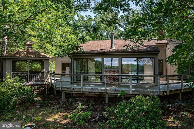 109 Kingfisher Cir, Weems, VA 22576 - back of property with a gazebo, a chimney, and a wooden deck