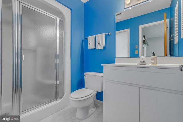 109 Kingfisher Cir, Weems, VA 22576 - bathroom with tile patterned flooring, a stall shower, toilet, vanity, and baseboards