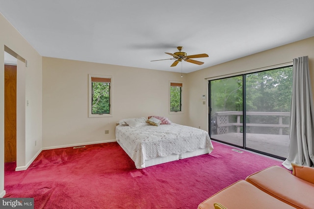 109 Kingfisher Cir, Weems, VA 22576 - carpeted bedroom featuring access to exterior, multiple windows, baseboards, and ceiling fan