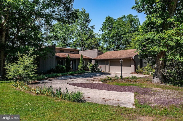 109 Kingfisher Cir, Weems, VA 22576 - back of property featuring concrete driveway and an attached garage