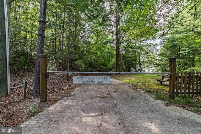 109 Kingfisher Cir, Weems, VA 22576 - gate with fence and a forest view