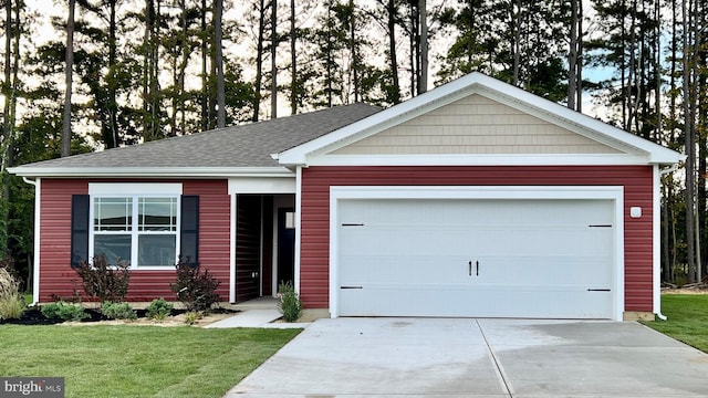 ranch-style house with driveway, an attached garage, a front lawn, and roof with shingles