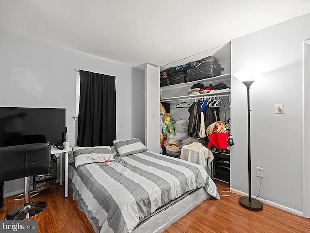 bedroom with a closet and wood finished floors