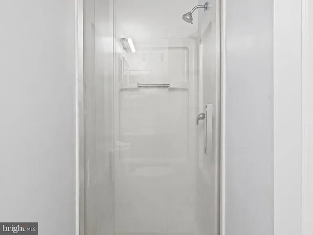 full bath featuring a shower stall