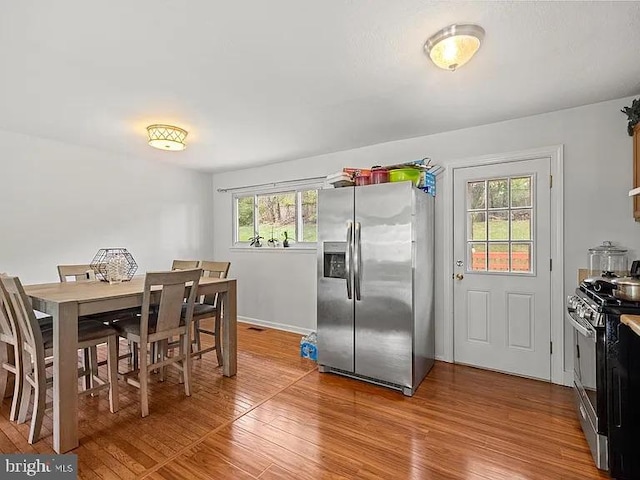 dining area with wood finished floors